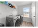 Laundry room with a front-load washer and dryer, shelf, and a window with a view at 125 Paperwhite Pl, Clayton, NC 27527
