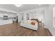 Bright, open-concept living room with a kitchen and dining area showcasing hardwood floors and neutral decor at 125 Paperwhite Pl, Clayton, NC 27527