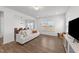 Bright living room and dining area with hardwood floors and neutral paint and a view of the outdoor scenery at 125 Paperwhite Pl, Clayton, NC 27527