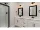 Modern bathroom boasting double sinks, a glass shower, and sleek, dark fixtures at 125 Prosecco Dr, Princeton, NC 27569