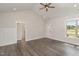 Bright bedroom with a large window, neutral paint, and wood-look flooring at 125 Prosecco Dr, Princeton, NC 27569