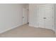 Clean bedroom with carpet, neutral walls, and a closet for storage and organization at 125 Prosecco Dr, Princeton, NC 27569