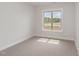 Neutral bedroom with plush carpeting and natural light from a large window at 125 Prosecco Dr, Princeton, NC 27569