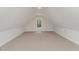 Spacious bonus room with a window, neutral carpet, and sloped ceilings at 125 Prosecco Dr, Princeton, NC 27569