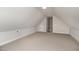 Large, carpeted bonus room with neutral walls and access to additional storage space at 125 Prosecco Dr, Princeton, NC 27569