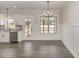 Dining area with view of kitchen, outdoor access, and neutral-colored walls at 125 Prosecco Dr, Princeton, NC 27569