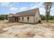 Beige single story home with a screened in porch in a residential neighborhood at 125 Prosecco Dr, Princeton, NC 27569