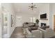 Bright living room featuring a fireplace, vaulted ceilings, and wood-look flooring at 125 Prosecco Dr, Princeton, NC 27569