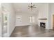 Bright living room featuring a fireplace, vaulted ceilings, and wood-look flooring at 125 Prosecco Dr, Princeton, NC 27569