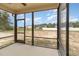 View from the screened-in back porch to a construction lot and neighborhood homes at 125 Prosecco Dr, Princeton, NC 27569