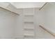 Walk-in closet with built in shelving and wooden rails, offering ample storage at 125 Prosecco Dr, Princeton, NC 27569