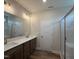 Bathroom showcasing double sinks, a large mirror with modern lighting, and a glass shower at 125 Tuskeegee Dr, Smithfield, NC 27577