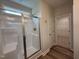 Bathroom featuring a glass shower with a bronze shower head and door handle and wooden floors at 125 Tuskeegee Dr, Smithfield, NC 27577