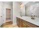 Bathroom featuring double sinks, wood cabinetry, and a large mirror at 125 Tuskeegee Dr, Smithfield, NC 27577