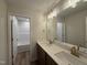 Bathroom displaying a double vanity, a framed mirror with contemporary lighting, and a shower-tub combo at 125 Tuskeegee Dr, Smithfield, NC 27577