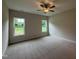 Bright bedroom with neutral carpet, two windows, and light beige walls at 125 Tuskeegee Dr, Smithfield, NC 27577