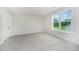 Bright bedroom with large window offering natural light, neutral carpet, and a closet at 125 Tuskeegee Dr, Smithfield, NC 27577