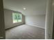 Comfortable carpeted bedroom with a large window, offering a peaceful view at 125 Tuskeegee Dr, Smithfield, NC 27577