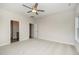 Neutral bedroom featuring a ceiling fan and two doors at 125 Tuskeegee Dr, Smithfield, NC 27577