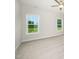 A bedroom featuring two large windows and neutral carpeting at 125 Tuskeegee Dr, Smithfield, NC 27577