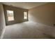 Bedroom featuring two windows, neutral walls, and ample space at 125 Tuskeegee Dr, Smithfield, NC 27577