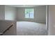Spacious bonus room with plush carpeting, a large window, and neutral paint at 125 Tuskeegee Dr, Smithfield, NC 27577