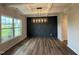 Spacious dining room featuring wood floors, a decorative accent wall, and coffered ceiling at 125 Tuskeegee Dr, Smithfield, NC 27577