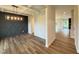 Bright dining room featuring wood floors, a decorative accent wall, and a coffered ceiling at 125 Tuskeegee Dr, Smithfield, NC 27577