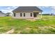Back exterior view of a two-story home with multiple windows at 125 Tuskeegee Dr, Smithfield, NC 27577