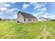 Exterior view of a home with green space, a well-kept lawn, and a dark roof at 125 Tuskeegee Dr, Smithfield, NC 27577