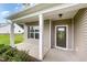 Inviting front porch featuring white columns, neutral siding, and a stylish front door with glass insert at 125 Tuskeegee Dr, Smithfield, NC 27577
