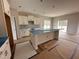 Well-lit kitchen featuring an island, sleek countertops, and ample cabinet space at 125 Tuskeegee Dr, Smithfield, NC 27577