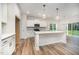 Modern kitchen with white cabinetry, stainless steel appliances, and a spacious island with pendant lighting at 125 Tuskeegee Dr, Smithfield, NC 27577