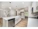 Bright open kitchen with white cabinets, stainless steel appliances and a large island at 125 Tuskeegee Dr, Smithfield, NC 27577