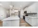 Bright kitchen with white cabinets, quartz countertops, patterned backsplash, and stainless steel appliances at 125 Tuskeegee Dr, Smithfield, NC 27577