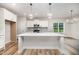 Stylish kitchen featuring a center island with pendant lights, stainless steel appliances, and white cabinets at 125 Tuskeegee Dr, Smithfield, NC 27577