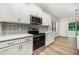 A kitchen featuring stainless steel appliances, white cabinets, modern countertops, and decorative backsplash at 125 Tuskeegee Dr, Smithfield, NC 27577