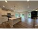 Open concept kitchen featuring white cabinets, stainless steel appliances, and a kitchen island at 125 Tuskeegee Dr, Smithfield, NC 27577