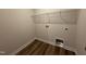 Small laundry room with hookups and wire shelving over wood floor at 125 Tuskeegee Dr, Smithfield, NC 27577