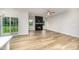 Bright living room featuring a fireplace, sliding glass doors, and luxury vinyl plank flooring at 125 Tuskeegee Dr, Smithfield, NC 27577