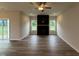 Spacious living room featuring wood floors, a fan, a black fireplace, and sliding doors at 125 Tuskeegee Dr, Smithfield, NC 27577