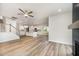 Spacious living space featuring luxury vinyl plank flooring, white kitchen, and an open floor plan at 125 Tuskeegee Dr, Smithfield, NC 27577