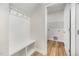 Mudroom featuring built-in bench with storage and hooks, next to a laundry room at 125 Tuskeegee Dr, Smithfield, NC 27577