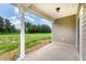 Covered porch with a view of the lush green backyard, offering outdoor relaxation at 125 Tuskeegee Dr, Smithfield, NC 27577