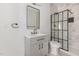 Modern bathroom featuring gray vanity, marble tile shower with black framed glass door at 13 St Augustine, Raleigh, NC 27610