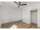 Bedroom with wood floors, a ceiling fan, and a closet with sliding doors at 13 St Augustine, Raleigh, NC 27610