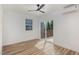 Bright bedroom featuring wood floors, a ceiling fan, and sliding glass door to a private deck at 13 St Augustine, Raleigh, NC 27610