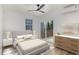 Staged bedroom featuring wood floors, a ceiling fan, and sliding glass door to a private deck at 13 St Augustine, Raleigh, NC 27610