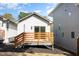 Rear exterior view of a white home featuring a wooden deck and a gray home at 13 St Augustine, Raleigh, NC 27610