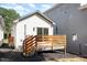 Rear exterior view of a white home featuring a wooden deck and a gray home at 13 St Augustine, Raleigh, NC 27610